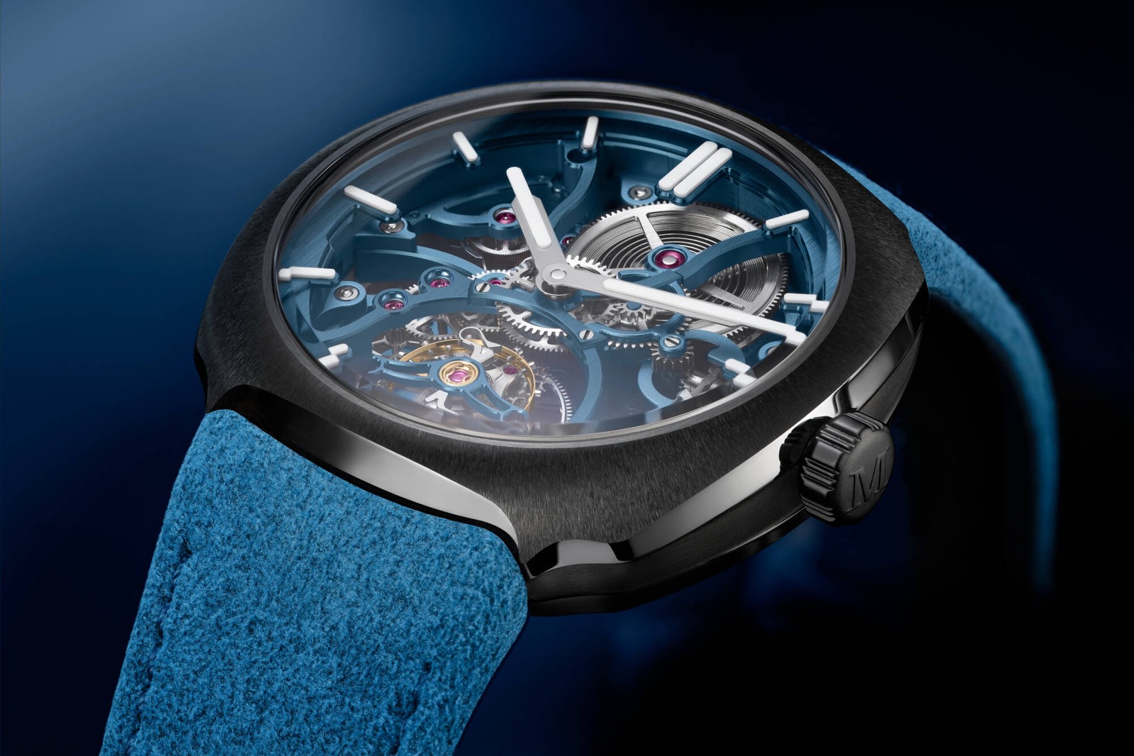 Close-up of a grey ceramic watch with a blue skeletonised movement and tourbillon, on a blue Alcantara strap